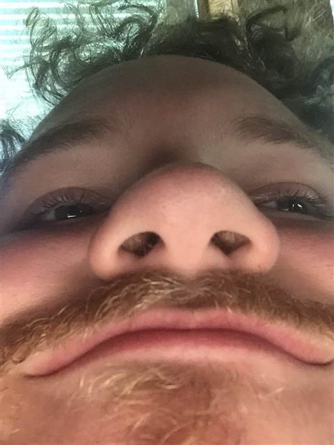 An extreme close-up looking up a guest's nose